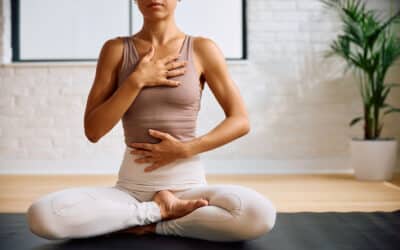 Zen-like woman doing Yoga breathing exercise in health club.